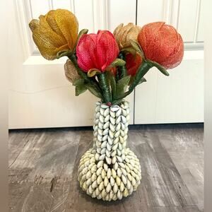 Vintage folk art cowrie sea shell vase with woven straw flowers